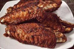 three pieces of meat sitting on top of a white plate