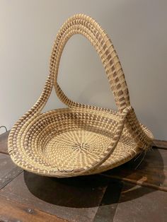 a wicker basket sitting on top of a wooden table