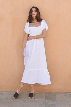 Style // The perfect white linen dress, with extra lining in the skirt to ensure the brightest color The Soller Dress is a feminine, flirty and fun dress for any occasion. A midi to long dress with a tiered skirt, the square neckline and puffed sleeves make it a dreamy addition to any wardrobe. It features and elastic bodice and tie detailing on the back to ensure the best possible fit. The dress has some structure while leaving plenty of room for comfort and ease, for an effortless approach to Vietnam Clothes, White Linen Dresses, Clothes Basket, Fun Dress, Farmers Markets, The Square, Knitwear Tops, Puffed Sleeves