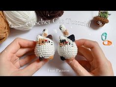 two small crochet cats sitting next to each other