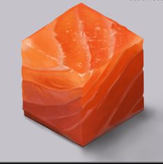 an orange cube is sitting on a gray surface with the top half covered in plastic