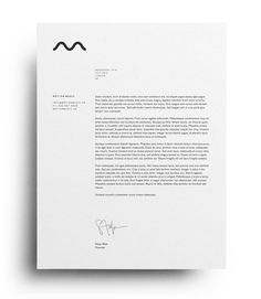 a letterhead with a black and white monogramic logo on it, sitting next to a piece of paper