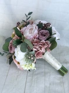 a bridal bouquet with pink and white flowers