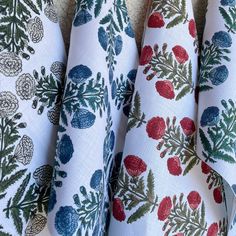 four different types of fabric with flowers and leaves on them, all in various colors