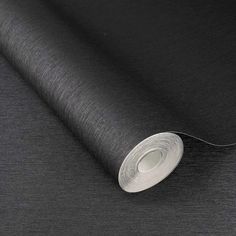 a roll of black fabric on top of a table