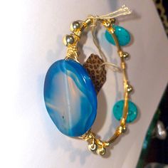 Turquoise And Blue Agate Bangle. With Gold Hematite Beads. Wire Wrapped In Gold Plated Non Tarnishing Wire . I Wear My Own All The Time And They Haven’t Tarnished Yet !! Cute Round Button Style Turquoise Beads On The Sides . This Is A Nice Weighted Bangle One Of A Kind. It’s 3 Inches Wide. If Your Wrist Is Slightly Bigger Than 8 Inches This Will Fit Fine. If Your Wrist Is Less Than 8 Inches It Will Be A Little To Big. Measure Your Middle If Your Hand For The Right Size Wooden Bangle Bracelet, Wooden Bangle, Black Leather Bracelet, Wood Bracelet, Buckle Bracelet, Button Style, Round Button, Sterling Silver Filigree, Hematite Beads