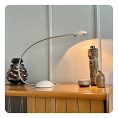 Vintage arched Meblo table lamp, Yugoslavia circa 1970. Off white painted metal base and shade, chrome plated arched neck. Halogen type light bulb. Cleaned and mildly polished, light wear consistent to age. Banker Lamp, Bankers Lamp, Off White Paints, Lamp Desk, Painted Metal, Postmodernism, Live Light, Metallic Paint, White Paints