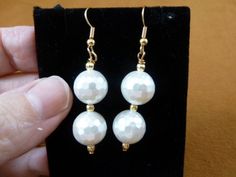 (Internal #EE473-61) This is a beautiful pair of beaded dangle earrings, two white faceted Mother of Pearl 12mm, gold brass textured spacer beads 3mm, on gold alloy French wires.Hypoallergenic french wires.This is a nice pair of earrings, for a classic look.This is exactly what you would receive.WE SHIP WORLDWIDE! Other accepted payment: Credit card (Mastercard/Visa/Discover) inquire for details. White Faceted Beads Beaded Earrings Gift, Pearl White Faceted Beads Jewelry Gift, White Faceted Beaded Earrings As A Gift, Pearl White Jewelry With Faceted Beads As Gift, Pearl White Jewelry With Faceted Beads For Gifts, White Dangle Earrings With Faceted Beads, White Faceted Beads Dangle Jewelry, White Faceted Beads Drop Earrings, White Dangle Earrings With Faceted Details