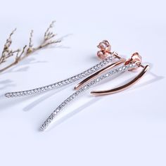 Sweet and sparkling, these dazzling earrings create a perfect look for everyday style or special moments. A curved ribbon of rose gold color add femininity to this design, while sparking round stones add extra shimmer. A romantic gift, these sparkling earrings are a sweet treat.Carat Weight: 0.58 ctStone Size: 1.1 mmNumber of Stones: 58 Stone Shape: RoundStone Color: Diamond WhiteWeight: 3.4 gWidth: 2.07 mmHeight: 35.6 mmMaterial: 925 SilverPlating Color: Silver, Rose Gold Jeulia Jewelry, Dazzling Earrings, Romantic Gift, Small Earrings, Fine Jewellery Earrings, Online Earrings, Sweet Treat, Rose Gold Color, Jewelry Patterns