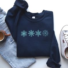 Personalized Christmas Embroidered Sweatshirt, Crewneck Tshirt Hoodie Snowflakes in Doodle Style For Winter, Christmas Gift, MADE IN USA There are two brands we use: Gildan and our own brand BeePro Handmade. Comfort Colors, Bella Canvas, and other brands are available upon request at a different price. If interested in adding embroidery to the sleeve please go to this listing: https://www.etsy.com/listing/1674502020 Because it is made to order, we don't accept the return or exchange unless we make a mistake We are unable to replace or refund purchases based on the color and the font selections. Please make sure to be very specific and make the correct selections when you place an order. Please feel free to reach out to us with any questions. We will do our best to make sure that you are co Winter Fleece Tops With Embroidered Graphics, Winter Embroidered Crew Neck Hoodie, Casual Embroidered Winter T-shirt, Winter Crew Neck Hoodie With Embroidered Graphics, Winter Sweatshirt With Embroidered Graphics, Embroidered Fleece Sweater For Winter, Winter Embroidered Fleece Sweater, Cotton Sweatshirt With Embroidered Graphics For Winter, Embroidered Long Sleeve T-shirt For Winter