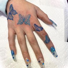 a woman's hand with blue butterflies on it