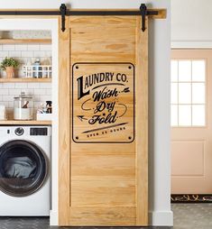 a laundry room door with the words laundry co written on it next to a washer and dryer