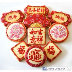 decorated cookies with chinese writing and flowers on them