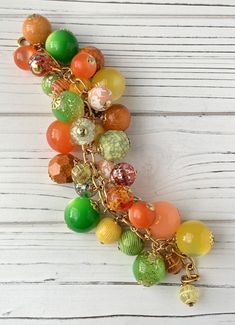 "Juicy hues in a mix of glass, resin and acrylic beads make this one delicious looking charm bracelet! Makes a great gift or treat yourself to add to your summer style collection. Gold plated brass chain bracelet measures 8 inches with 1 1/2\" extension. Thanks for visiting my Etsy!" Multicolor Lucite Jewelry For Gift, Multicolor Lucite Jewelry As Gift, Multicolor Lucite Jewelry Gift, Party Multicolor Czech Glass Bracelets, Multicolor Czech Glass Bracelets For Party, Multicolor Charm Bracelet With Round Beads, Pumpkin Garland, Pearl Charm Necklace, Chunky Pearls