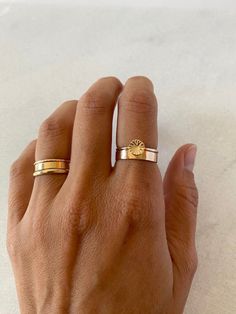 Bring some sunshine in your day with this dainty desert sun ring! Entirely handmade to order with durable 14k gold filled. Disk-6mm round (small), slight concave shape Sun rays are hand stamped.  Band is dainty and comfortable -1.3mm Last photos are stacking example.  Featured bands: https://www.etsy.com/listing/1518973531/wide-gold-band-cigar-band-gold-filled?click_key=c0a9f1b28d8addee0527f412b6b47db7af42c7b5%3A1518973531&click_sum=b382b6db&ref=shop_home_active_7&frs=1&sca=1&sts=1 Listing is only for the sun band. Model wears size 7. 14k Gold Filled Dainty Everyday Rings, Dainty 14k Gold Filled Rings For Everyday, Everyday Simple 14k Gold Filled Stackable Rings, Everyday Simple Stackable Rings In 14k Gold Filled, Everyday Stackable 14k Gold Filled Rings, Everyday Tiny Stackable 14k Gold Filled Rings, 14k Gold Filled Everyday Toe Rings, Dainty 14k Gold Midi Rings For Everyday, Everyday 14k Gold Filled Toe Stackable Rings