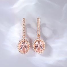 Elegance meets sophistication in this captivating design, where the lustrous morganite takes center stage, exuding a soft and enchanting hue. The halo of shimmering stones that surrounds it adds a touch of brilliance, creating a mesmerizing play of light and sparkle. These earrings are a testament to timeless beauty and impeccable craftsmanship. They effortlessly blend classic and contemporary styles, making them the perfect accessory for any occasion. Whether you're attending a glamorous soirée Elegant Morganite Jewelry, Elegant Oval Halo Earrings, Elegant Halo Rose Gold Earrings, Elegant Rose Gold Halo Earrings, Morganite Halo Design Jewelry For Formal Occasions, Elegant Morganite Halo Jewelry, Elegant Morganite Jewelry With Halo, Formal Morganite Halo Jewelry, Elegant Oval Rose Gold Earrings