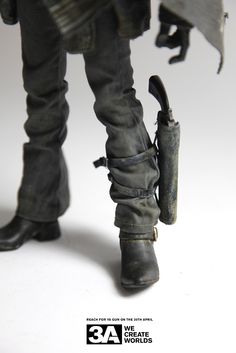 the legs and boots of a toy soldier holding an umbrella in his right hand while walking