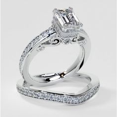 an engagement ring set with diamonds on top and side stones around the band, in white gold