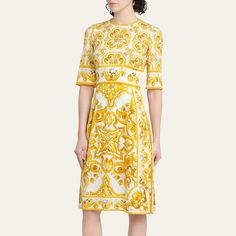 Dolce&Gabbana printed charmeuse dress Round neckline Elbow-length sleeves Side seam pockets A-line silhouette Knee length Back zip Silk/spandex Made in Italy Luxury Silk Sheath Dress, Luxury Fitted A-line Midi Dress, Designer Silk Dress With Floral Print, Designer Silk Floral Print Dress, Luxury White A-line Dress, Luxury Floral Print Summer Dress, Luxury Midi Length Daywear Dresses, Elegant Yellow Silk Dress, Designer Silk A-line Dress