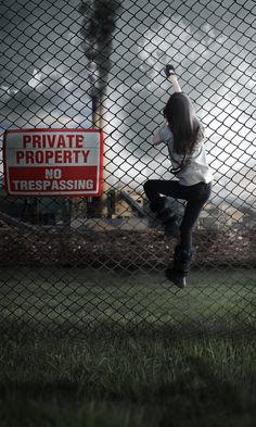 a person jumping in the air near a fence