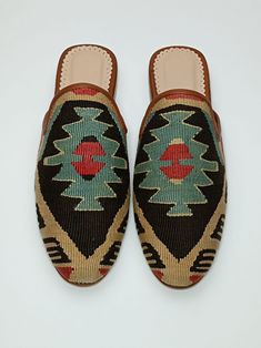 Welcome to AliDesignStore This Kilim Mules one -of-A-kind! Upper Made of a Hand-Selected Vintage Turkish Kilim Rug .  Kilims Rugs Are Hand Crafted From Vegetable Yarn. Have Stronger weave. - Handcrafted - Materials : Handwoven Kilim Rug                       Leather Sole                        Leather Trimmed                       Leather Lining                       Stacked Leather Sole                       Rubber Under The Stacked Heel  Care:   Soft Clothing Brush İs Recommended To Clean The Slipper. İf Something Spill on it.You Can Clean İt a Cloth With shampoo. - Ships from a small business in Turkey Traditional Brown Mules With Rubber Sole, Traditional Brown Mules With Leather Sole, Artisan Brown Slip-on Moccasins, Traditional Handmade Mules, Bohemian Handmade Slip-on Slippers, Bohemian Handmade Slip-on Mules, Handmade Bohemian Slip-on Mules, Traditional Brown Slip-on Loafers, Traditional Loafers With Leather Sole And Flat Heel