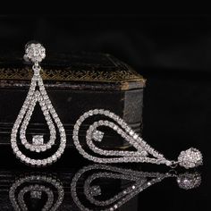 Stunning and elegant diamond drop earrings.Item #JP-E0021Metal: 14K White GoldWeight: 9.9 GramsDiamond Weight: Approx. 4 ctDiamond Color: HDiamond Clarity: SI1Measurements: 44.85 x 18.74 mmLayaway: For your convenience, we will be happy to provide layaway payment options. Please contact us to work out a layaway plan which best suits your needs. All layaway purchases are final sale.All domestic and international shipments are shipped with FedEx insured with signature required. International Shipm Timeless Pear-shaped Diamond Earrings For Formal Occasions, Formal Pear-shaped Brilliant Cut Earrings, Formal Diamond Earrings With Diamond Accents, Glamorous Diamond Bridal Earrings With Brilliant Cut, Formal Pear-shaped Diamond Bridal Earrings, Elegant Pear-shaped Diamond Earrings For Evening, Glamorous Bridal Earrings, Diamond With Brilliant Cut, Exquisite Vvs Clarity Diamond Earrings For Formal Occasions, Exquisite Vvs Clarity Diamond Earrings For Formal Events