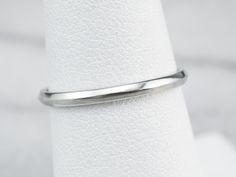 This simple white gold band is so versatile! Wear it as a wedding ring, create a ring stack, or wear it alone for a chic minimalist look. A nice detail is the knife edge profile that creates a subtle play of light! Metal: 18K White Gold Width of Band: 1.8 mm Height off Finger: 1.3 mm Ring Size: 6.75 Marks: "18K JABEL" Stamped on the inside band Minimalist Platinum Round Band Wedding Ring, Minimalist Platinum Wedding Band, Wedding Stackable Rings In White Gold With Thick Band, White Gold Thick Band Stackable Rings For Wedding, Minimalist Formal Bands With Smooth Bezel, Minimalist Bands With Smooth Bezel For Formal Occasions, Minimalist 14k White Gold Stackable Wedding Rings, Minimalist Rings With Decorative Band For Formal Events, Minimalist Rings With Decorative Band For Formal Occasions