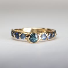 a gold ring with blue stones on it