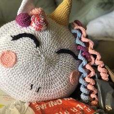 a crocheted stuffed animal with a unicorn's head on top of it