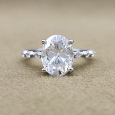 a close up view of a ring with a large diamond on it's side