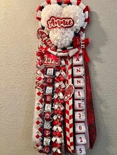 a red, white and blue tie with the name annie on it hanging from a wall