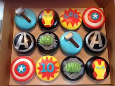 cupcakes in a box with captain america and iron man designs on them,