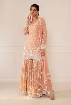 Editor's Note Featuring Peach Pink Embroidered Shirt & Gharara Set With Dupatta Fabric: Silk, Chiffon Color: Peach Pink  Embroidery Details: Zardozi Hand Embroidery Care: Dry Clean Only... Peach Indian Outfit, Sharara Suit Designs Latest, Pink Gharara, Punjabi Suit Boutique, Sharara Designs, Pink Embroidery, Indian Dresses Traditional, Dress Design Patterns, Sharara Set