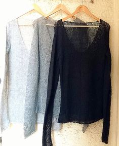 three sweaters hanging up on a rack