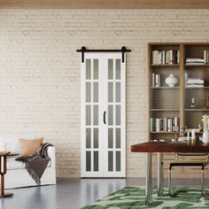 a living room filled with furniture and bookshelves next to a white brick wall