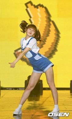 a girl in a blue and white dress is holding a tennis racquet on a court