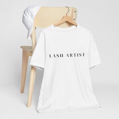 Welcome to the Basics Collection, where style meets simplicity for the modern Lash Technicians! Elevate your wardrobe with our Lash Artists Essentials Basic T-shirt, designed to keep you looking chic and feeling comfortable throughout your busy day of pampering. Crafted from premium, breathable fabric, this tee is a must-have addition to your professional attire. Embrace the versatility of our Basic Tees, available in a range of stunning colors to suit your unique aesthetic. Whether you're providing facial treatments, administering massages, or perfecting brows, our tee offers the perfect blend of style and functionality. But this isn't just any ordinary tee - it's a statement piece that speaks volumes about your dedication to your craft. As you work your magic on clients, let our tee be a Modern Short Sleeve T-shirt With Branding, Modern Cotton T-shirt With Branding, Minimalist Graphic Print T-shirt With Short Sleeves, Modern Short Sleeve T-shirt With Letter Print, Minimalist Short Sleeve T-shirt For Summer, Simple Relaxed Fit T-shirt With Graphic Print, Relaxed Fit Cotton Tops With Basic Design, Relaxed Fit Basic Cotton Top, Cotton Tops With Relaxed Fit