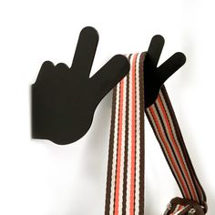 a pair of gloves hanging on the side of a striped tie with two fingers sticking out of it