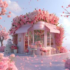 a pink store with flowers on the roof and tables in front of it, surrounded by petals