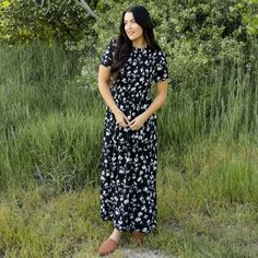 100% Polyester Model is 5'5" and is wearing a Small Modest Black Flowy Maxi Dress, Black Maxi Dress With Relaxed Fit For Spring, Black Flowy Maxi Dress Modest Style, Black Relaxed Fit Maxi Dress For Spring, Black Casual Maxi Dress With Relaxed Fit, Casual Black Relaxed Fit Maxi Dress, Black Relaxed Fit Maxi Dress, Modest Black Floral Print Maxi Dress, Modest Black Spring Midi Dress