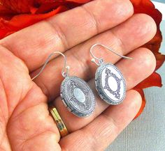 Oval shaped burnish antique silver oval locket earrings are engraved on both sides, with Victorian style different patterns/motifs. Locket earrings are hanging from silver ear wires. Please feel free to add any extra charms to these items: https://www.etsy.com/shop/ManoCelebrates?ref=seller-platform-mcnav&section_id=11071842 I have matching locket necklace with that too: https://www.etsy.com/listing/154601698/ox-oval-silver-locket-bird-sparrow?ga_search_query=oval+locket&ref=shop_items_s Antique Silver Engraved Earrings Gift, Antique Silver Engraved Earrings For Gift, Silver Oval Earrings With Intricate Design, Antique Silver Oval Earrings, Antique Oval Silver Earrings, Nickel Free Antique Silver Oval Jewelry, Victorian Silver Oval Earrings, Victorian Style Silver Oval Earrings, Antique Silver Oval Jewelry With Oxidized Finish