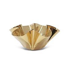 a gold plate that is sitting on a white surface and has been designed to look like an origami