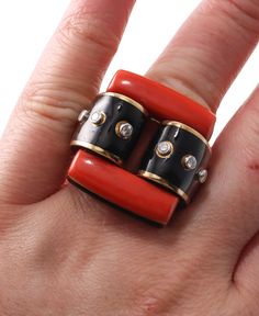 Iconic David Webb Domino ring, set in 18k gold and platinum, featuring coral, approx. 0.30ctw SI1/H diamonds and black enamel. DESIGNER: David Webb MATERIAL: 18k Gold / Platinum GEMSTONES: Diamond, Coral DIMENSIONS: Ring size 5, top is 25mm x 28mm. MARKED/TESTED: Webb, Plat, 18k. WEIGHT: 35.1 grams CONDITION: Previously Owned, Excellent Condition. David Webb Jewelry, Domino Ring, David Webb, Gold Enamel, Gold Platinum, Black Enamel, Ring Set, Gold Rings, Platinum