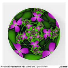 a green and purple circular object with flowers on it