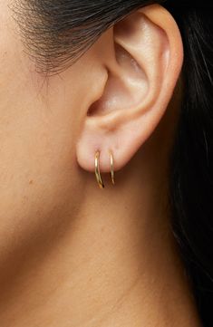 These hoops add the coolest detail to your look as they wrap around your ear, giving you the illusion of two piercings in one.How to wear: place thinner post through piercing. Turn earring approximately 2-3 times until both hoops are showing in the front to make a perfect double-pierced look. Avoid bending, style is delicate. Recycled Sterling Silver dipped in 14K Gold Delicate style, please handle with care Width: 5.5mm - 0.22" Depth: 13mm - 0.51" Weight: 0.60g Hoop Diameter: 13mm - 0.51” Post: Faux Double Hoop Earrings, Double Piercing Earrings, Two Piercings, Second Ear Piercing, Double Earring, Double Ear Piercings, Double Earrings, Double Piercing, Second Piercing