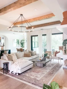 a living room filled with furniture and lots of windows