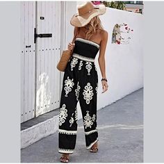 Turn heads with this ethnic print strapless wide-leg jumpsuit. Ideal for beach days and summer adventures, this jumpsuit offers a stylish and relaxed fit, perfect for any casual occasion. Features: Strapless design High waist with elastic band Intricate ethnic print Ankle-length wide-leg pants Size & Fit Size: S, M, L, XL Fit Style: Regular, comfortable fit Materials & Care Material: Polyester Care Instructions: Hand wash cold, gentle cycle. Do not bleach. Hang dry. Note: Lightweight fabric, per Bohemian Maxi Length Jumpsuits And Rompers For Vacation, Bandeau Jumpsuits And Rompers With Elastic Waistband For Spring, Bandeau Strapless Jumpsuit With Elastic Waistband, Summer Bandeau Jumpsuits And Rompers With Elastic Waistband, Summer Bandeau Jumpsuit With Elastic Waistband, Black Bohemian Jumpsuit For Vacation, Summer Strapless Jumpsuit For Day Out, Strapless Sleeveless Jumpsuit For Beach Vacation, Bohemian Spring Jumpsuits And Rompers With Elastic Waistband