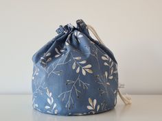 a blue bag sitting on top of a table next to a white wall and floor