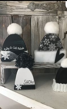 three hats are sitting on a shelf with snow written on the top and below them