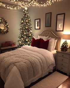 a bedroom decorated for christmas with lights on the ceiling and a tree in the corner